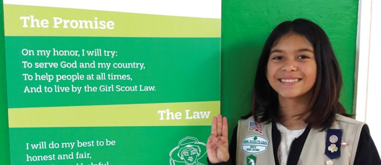 Taylor with Girl Scout Promise poster.